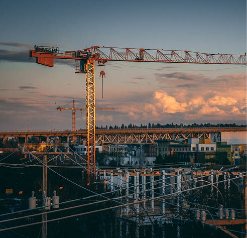 A beautiful view of a construction site in a city during sunset